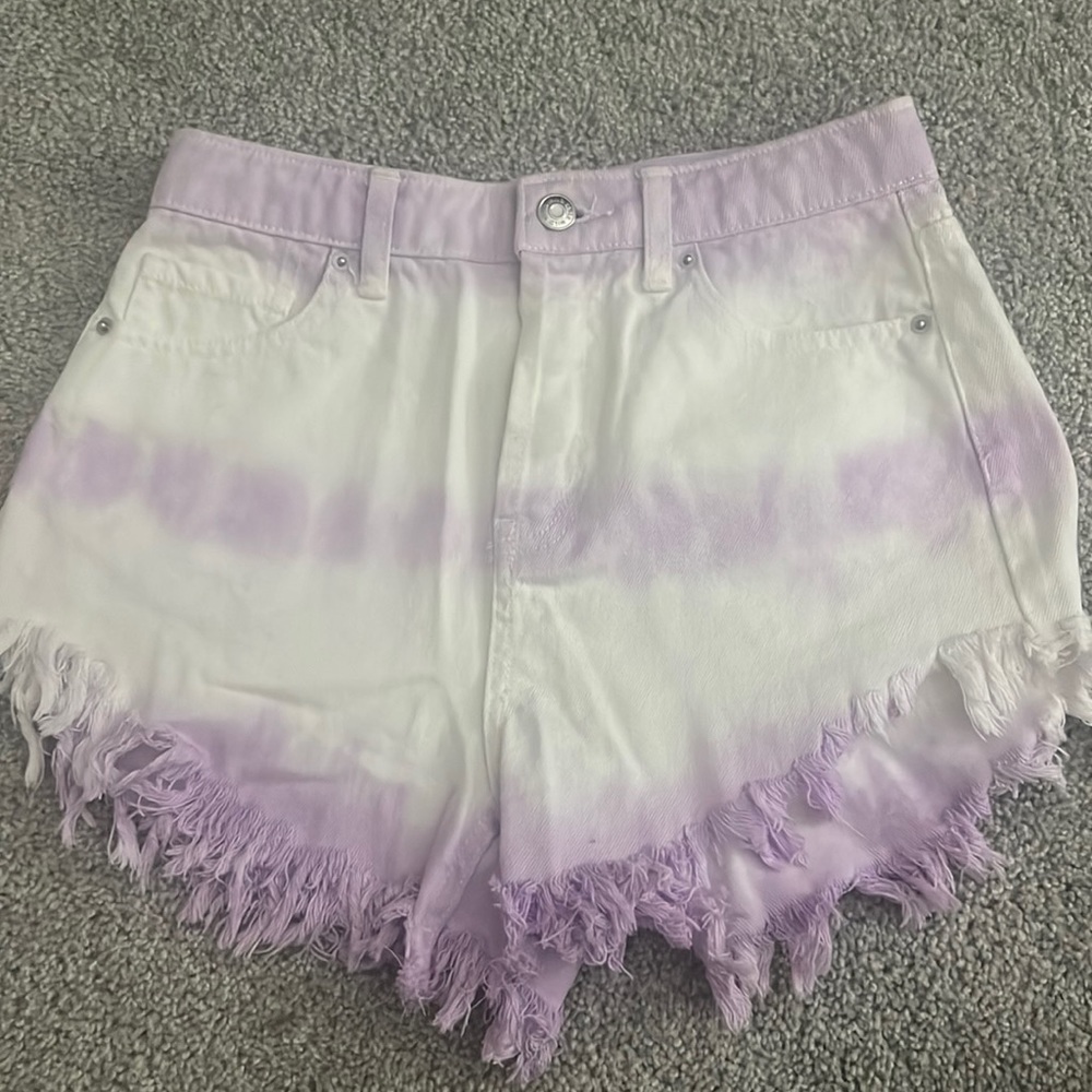 These cute tie die purple and white shorts. They are frayed at the bottom.